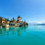 Experience the enchanting Oberhofen Castle on the turquoise shores of Lake Thun in Switzerland.